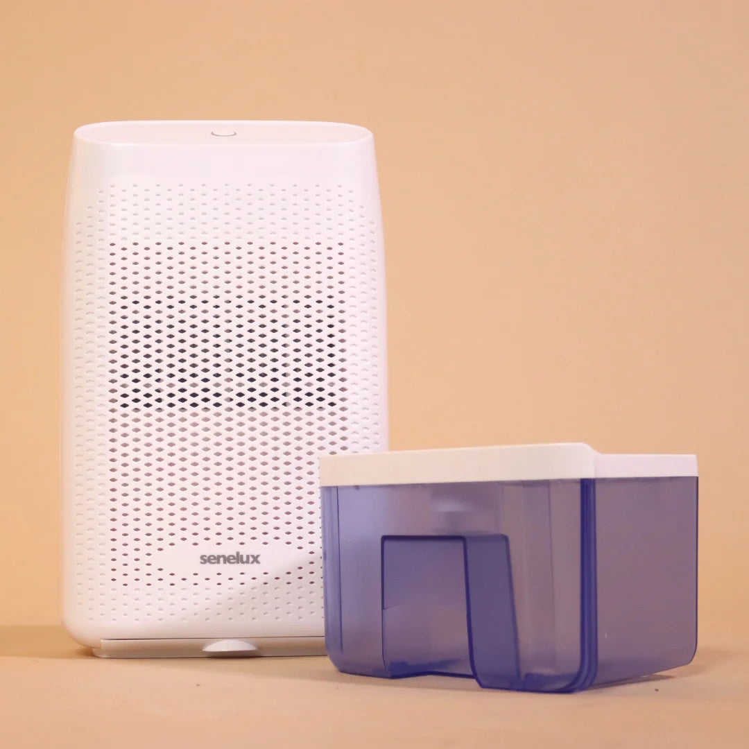 A photo of the Senelux T8 Plus Dehumidifier against an orange background with its purple water tank next to it