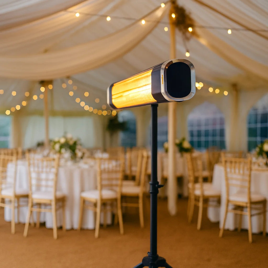 Heater in a tented outdoor wedding setup with tables and chairs.