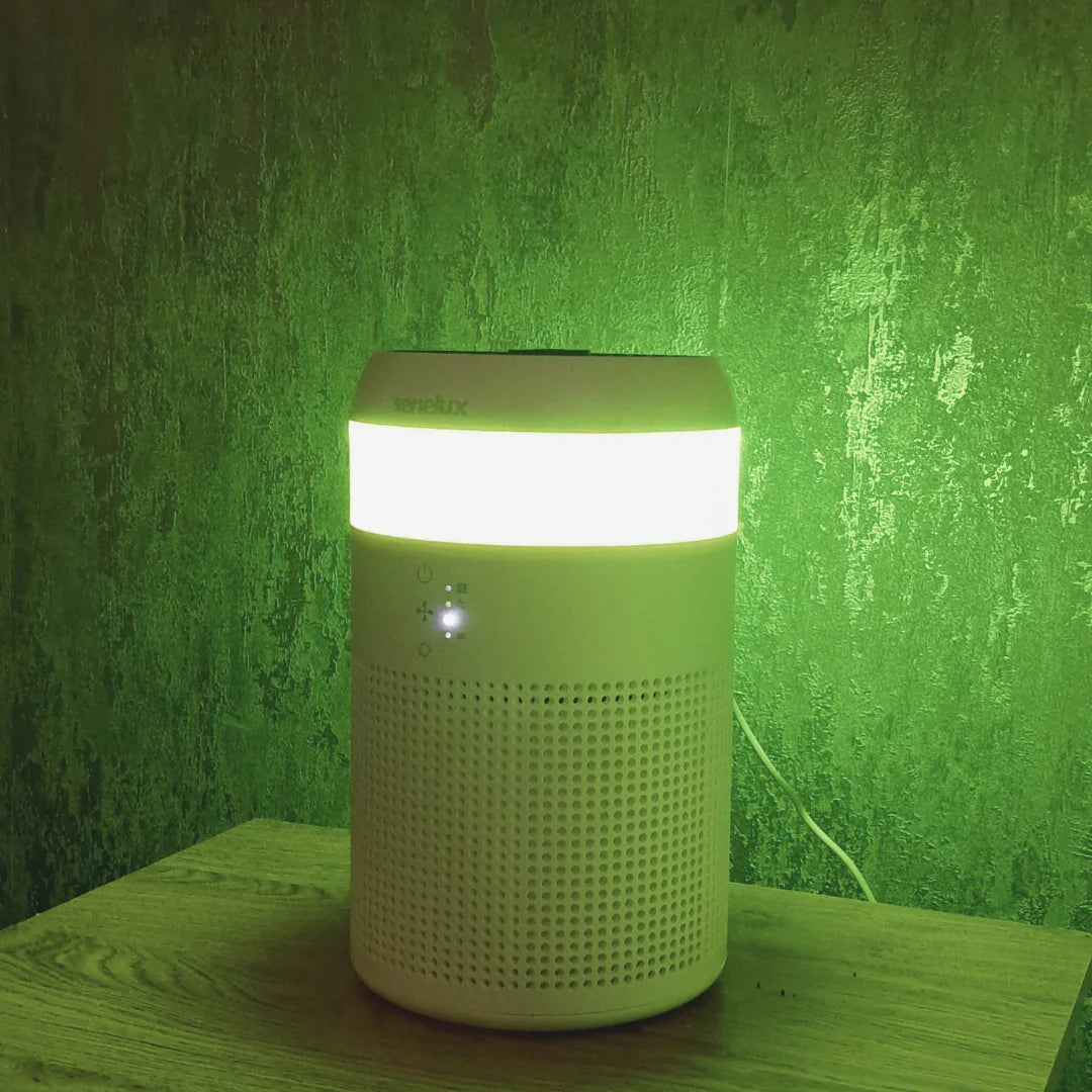 The Senelux Demi Air Purifier glowing with a yellow colour in a bright Spring room
