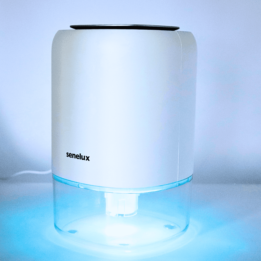The Senelux Q4 Dehumidifier set against a white background with a glowing blue LED light visible from the bottom.